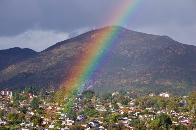 NOMINATED A suburban neighborhood nestled in the trees and mountains gets a beautiful rainbow to